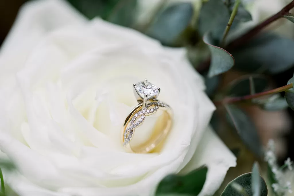 image of gold wedding band o white rose showing sustainable jewellery